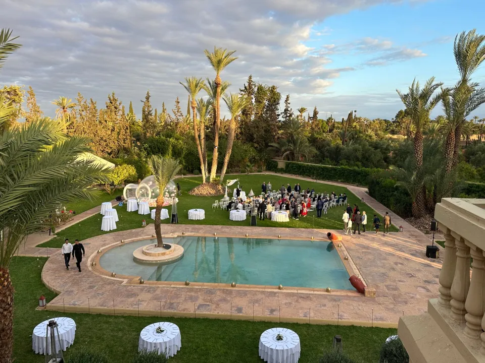 A wedding ceremony on the great lawn of the palace at golden hour