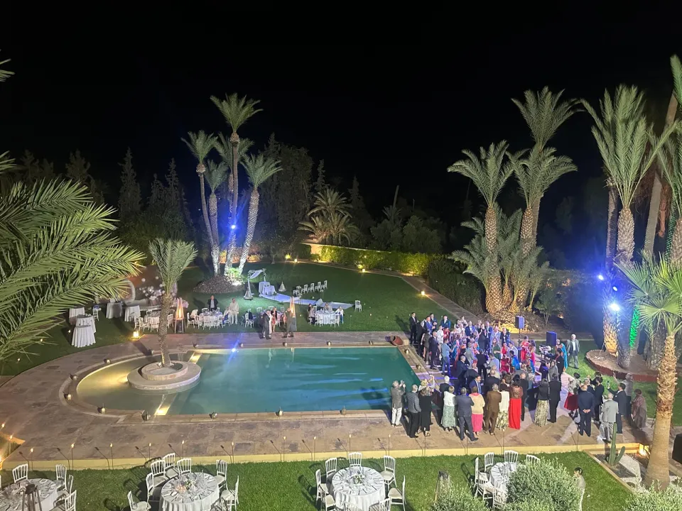 Evening celebration around the illuminated pool