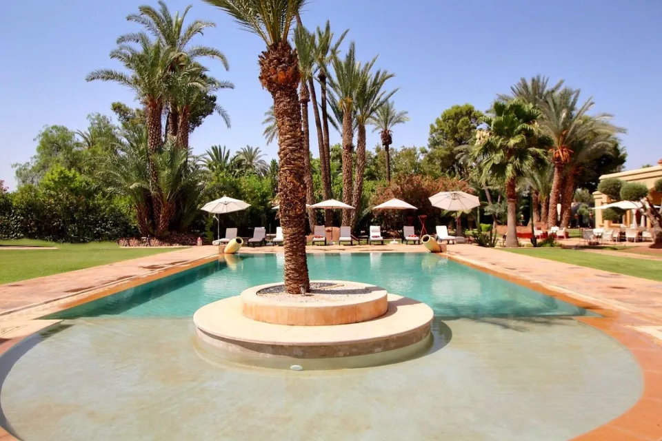 Heated pool with its central palm island in the gardens of the palace