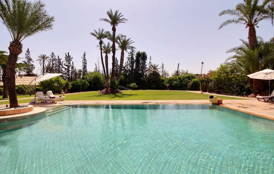 Pool and lawn of the estate under the Marrakech sky