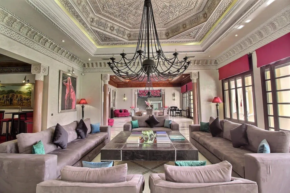 The grand salon lit by a wrought-iron chandelier