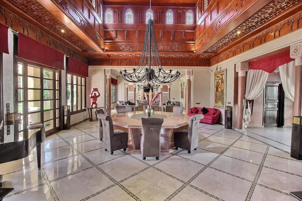The dining room set beneath the carved cedar ceiling